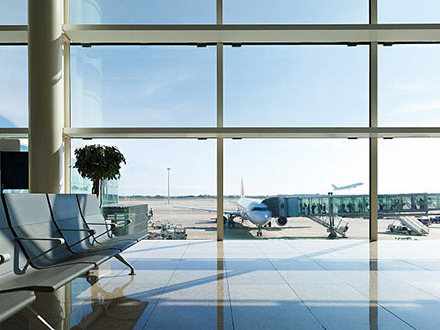 Airport terminal, people going to airplane in background